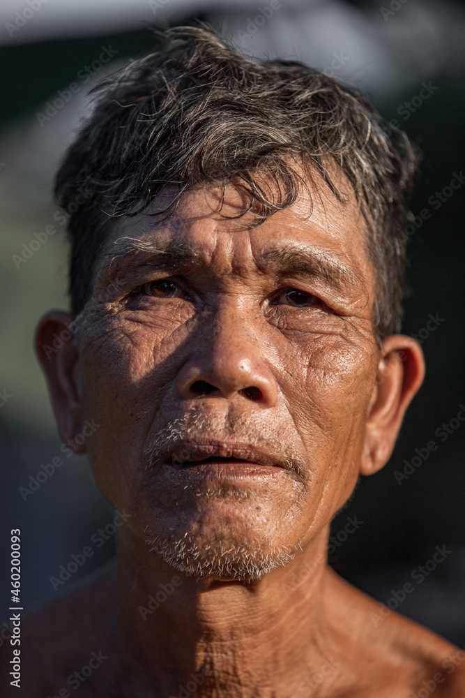 Portrait of older Asian male farmer, in rural Thailand