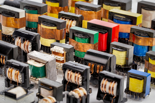 Photos Close up of many old used inductor copper electric ferrite power transformers