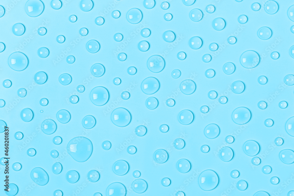 Water drops on a pastel blue background. Water texture close up. Backdrop glass covered with drops of water. Water bubbles