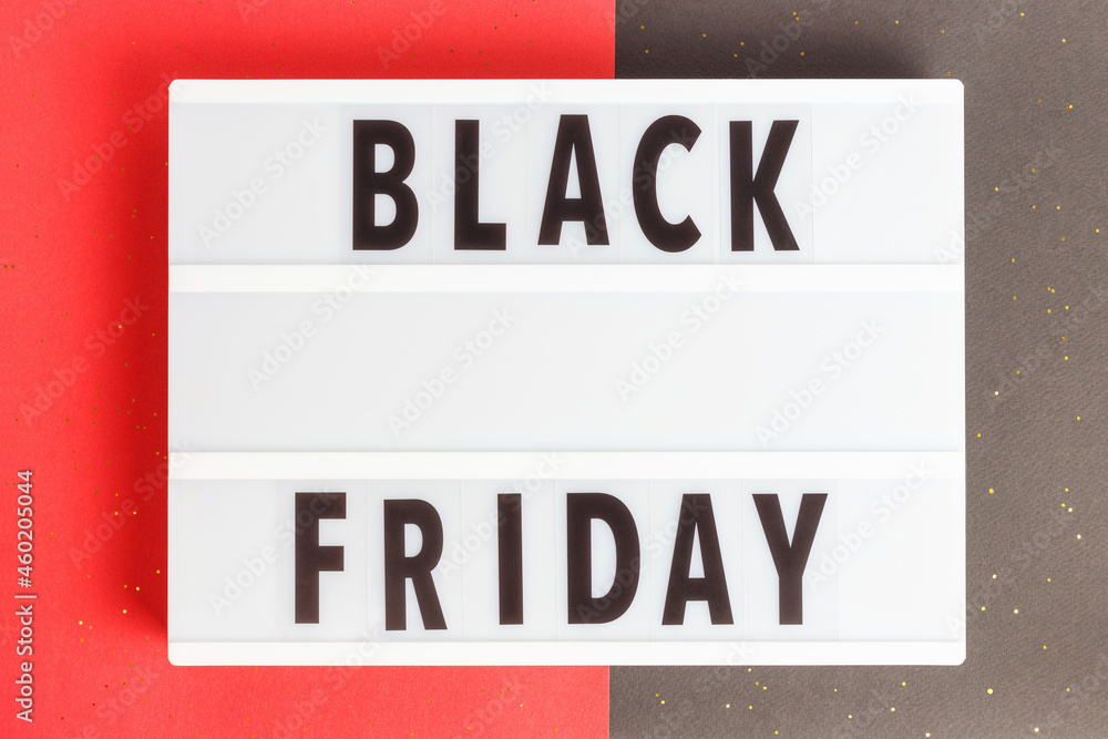 Fototapeta premium Inscription Black friday on a lightbox on black and red background top view.