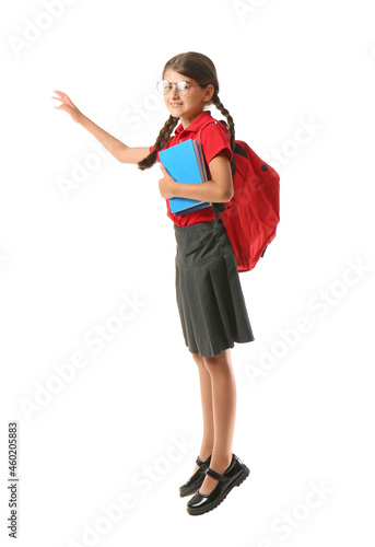 Jumping schoolgirl with book on white background