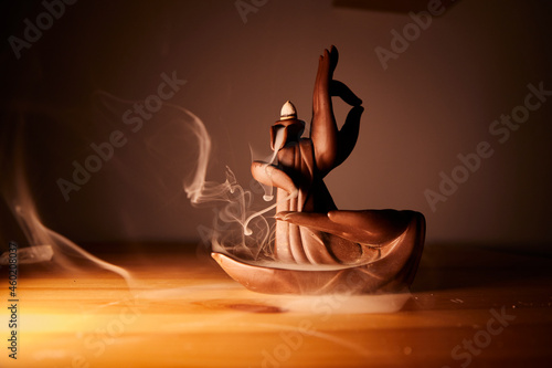 Fotografie, Obraz Buddhist hands statue with incense and smoke cascade