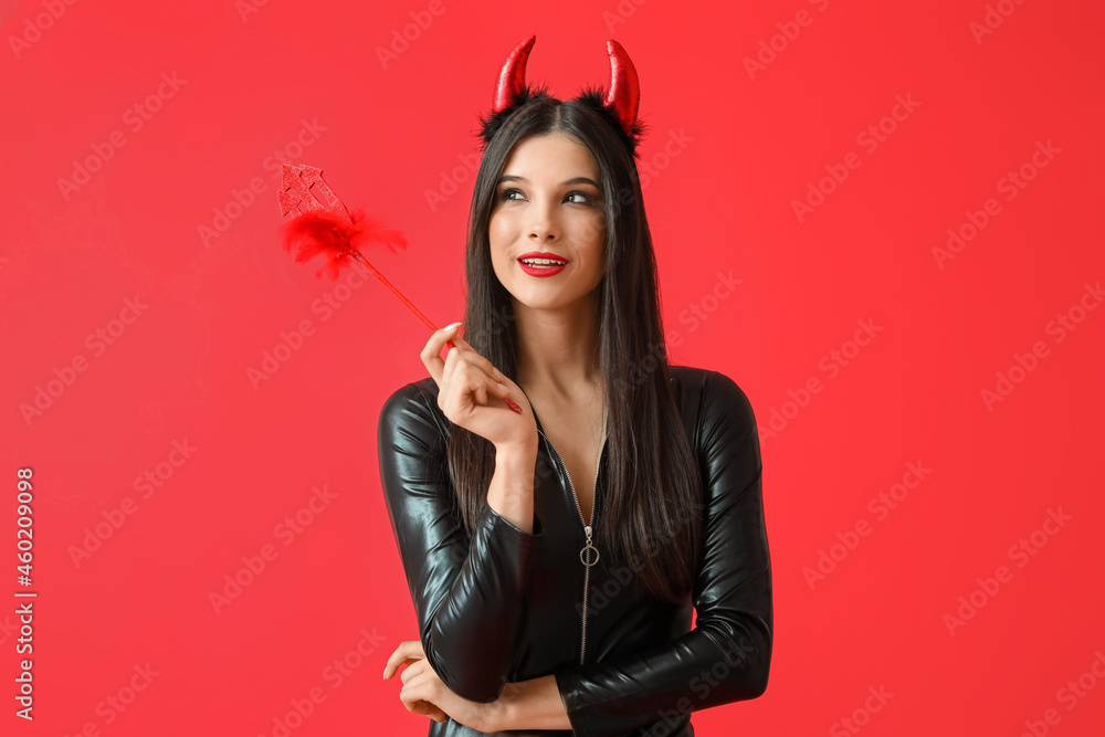 Beautiful young woman in Halloween costume on color background Beautiful young woman in Halloween costume on color background