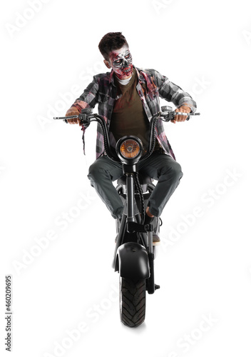 Man dressed for Halloween as zombie with motorcycle on white background © Pixel-Shot