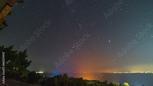 Night timelapse of stars moving in sky seen from Zakynthos island, shooting stars photo