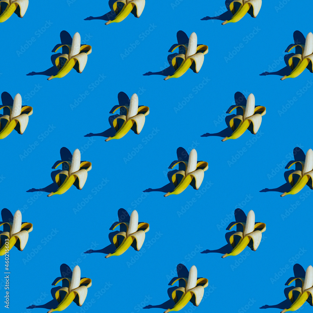 Fototapeta premium flat seamless pattern of peeled bananas on a blue background