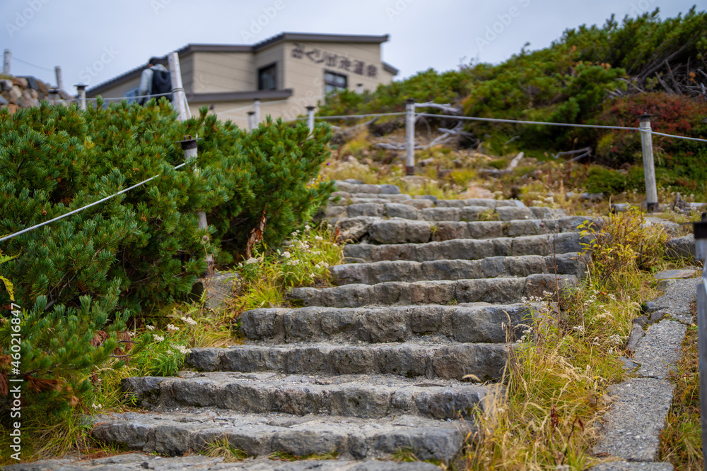富山県立山町の立山の秋の紅葉の季節に登山している風景 Scenery of climbing Tateyama Mountain in Tateyama Town, Toyama Prefecture, Japan during the season of autumn leaves. 富山県立山町の立山の秋の紅葉の季節に登山している風景 Scenery of climbing Tateyama Mountain in Tateyama Town, Toyama Prefecture, Japan during the season of autumn leaves.