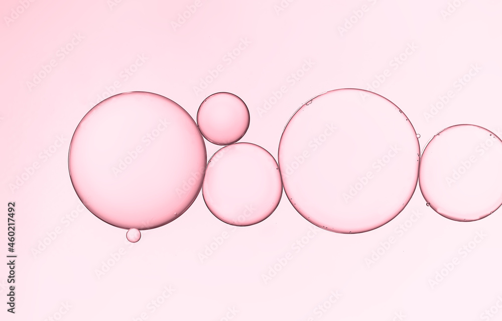Abstract water and oil droplets on pink gradient background. Abstract water and oil droplets on pink gradient background.