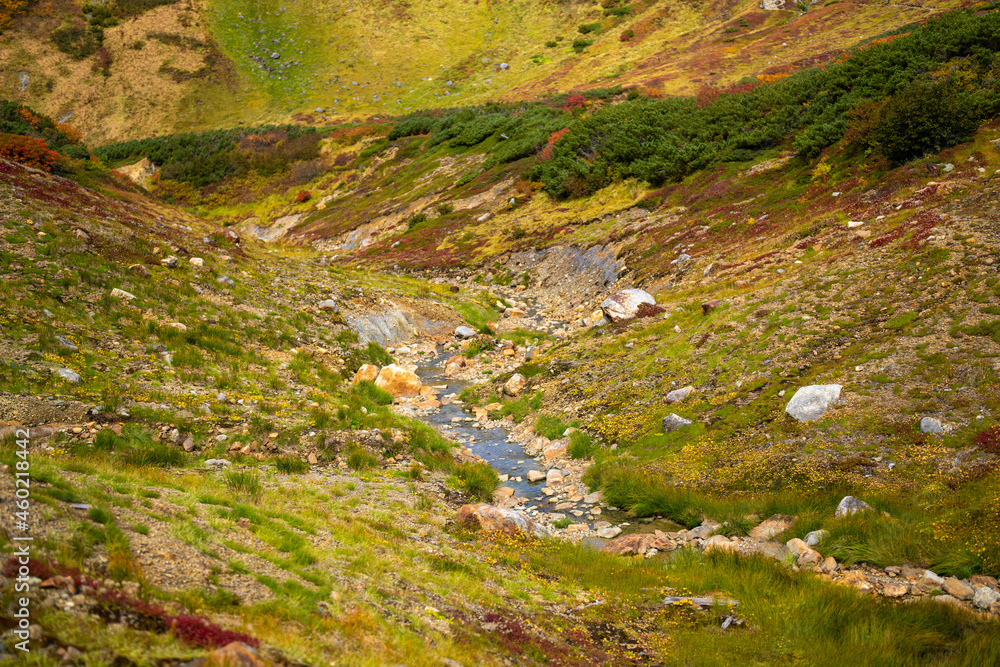 富山県立山町の立山の秋の紅葉の季節に登山している風景 Scenery of climbing Tateyama Mountain in Tateyama Town, Toyama Prefecture, Japan during the season of autumn leaves. 富山県立山町の立山の秋の紅葉の季節に登山している風景 Scenery of climbing Tateyama Mountain in Tateyama Town, Toyama Prefecture, Japan during the season of autumn leaves.