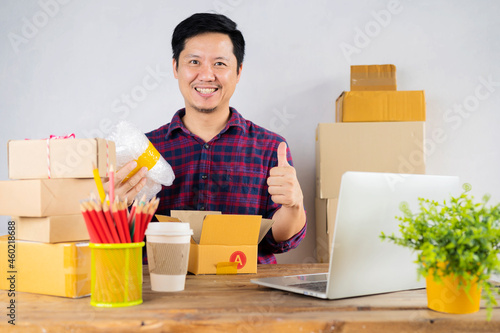 Small business owner packing in the cardbox at workplace.