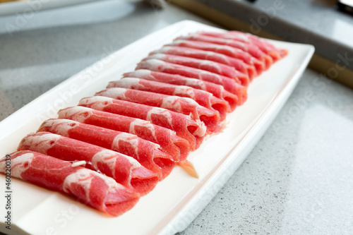 fresh raw pork belly sliced on plate in restaurant.