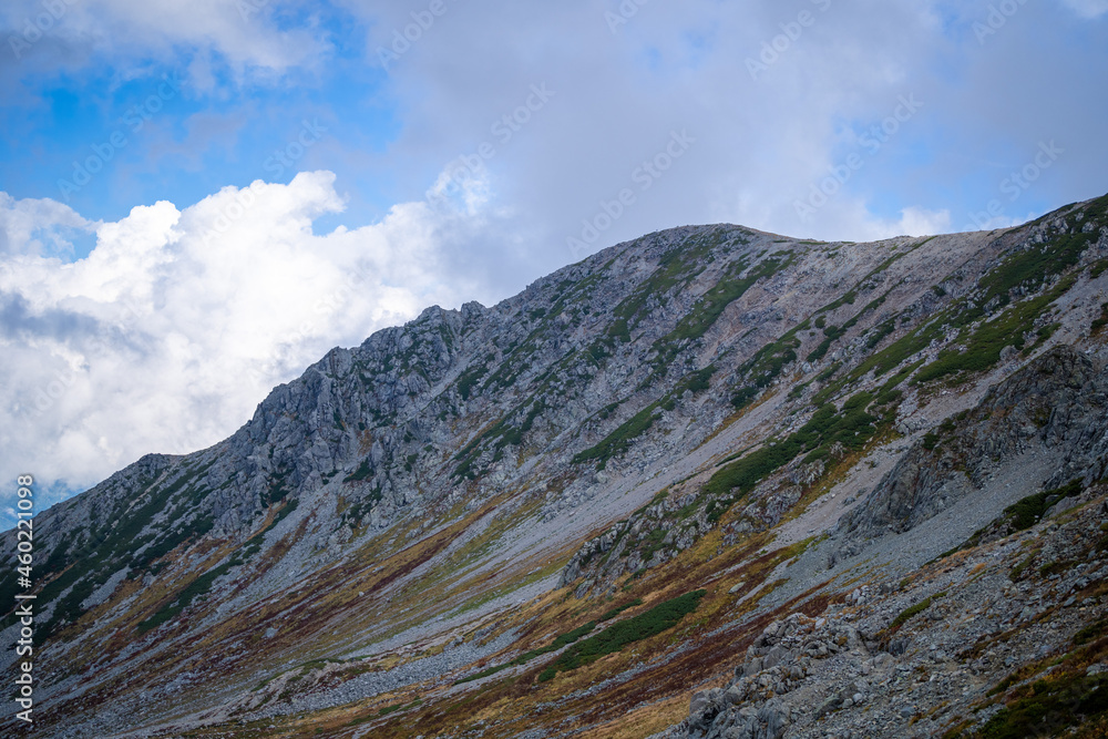 富山県立山町の立山の秋の紅葉の季節に登山している風景 Scenery of climbing Tateyama Mountain in Tateyama Town, Toyama Prefecture, Japan during the season of autumn leaves. 富山県立山町の立山の秋の紅葉の季節に登山している風景 Scenery of climbing Tateyama Mountain in Tateyama Town, Toyama Prefecture, Japan during the season of autumn leaves.