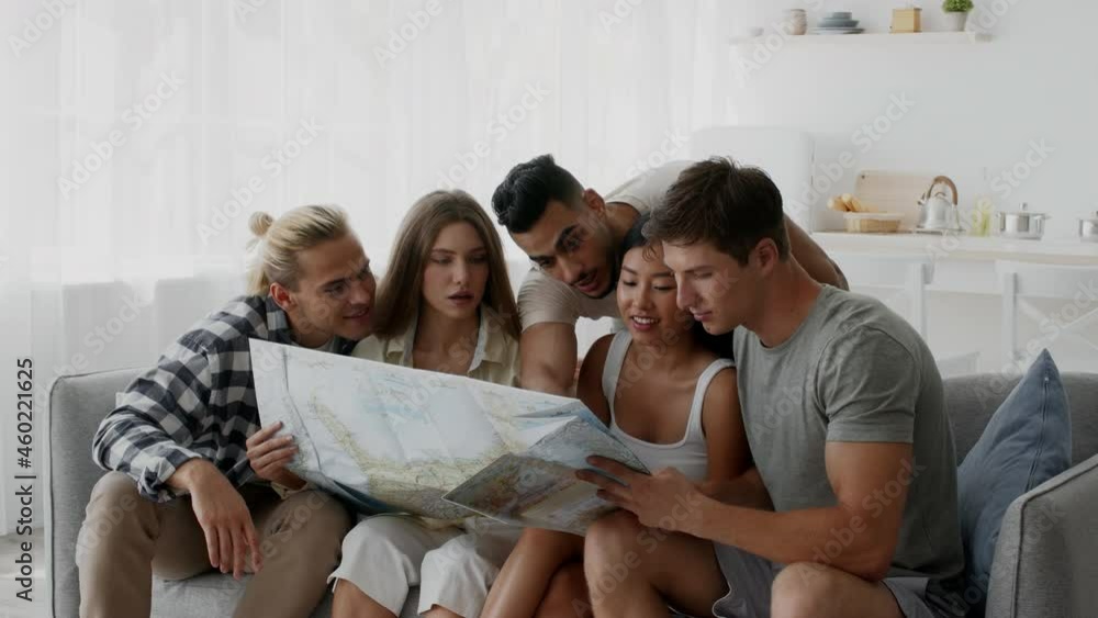 Group Of Multicultural Friends Planning Vacation Together, Sitting On Couch At Home Group Of Multicultural Friends Planning Vacation Together, Sitting On Couch At Home