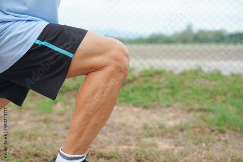 an old man legs muscles while stretching before exercise photo