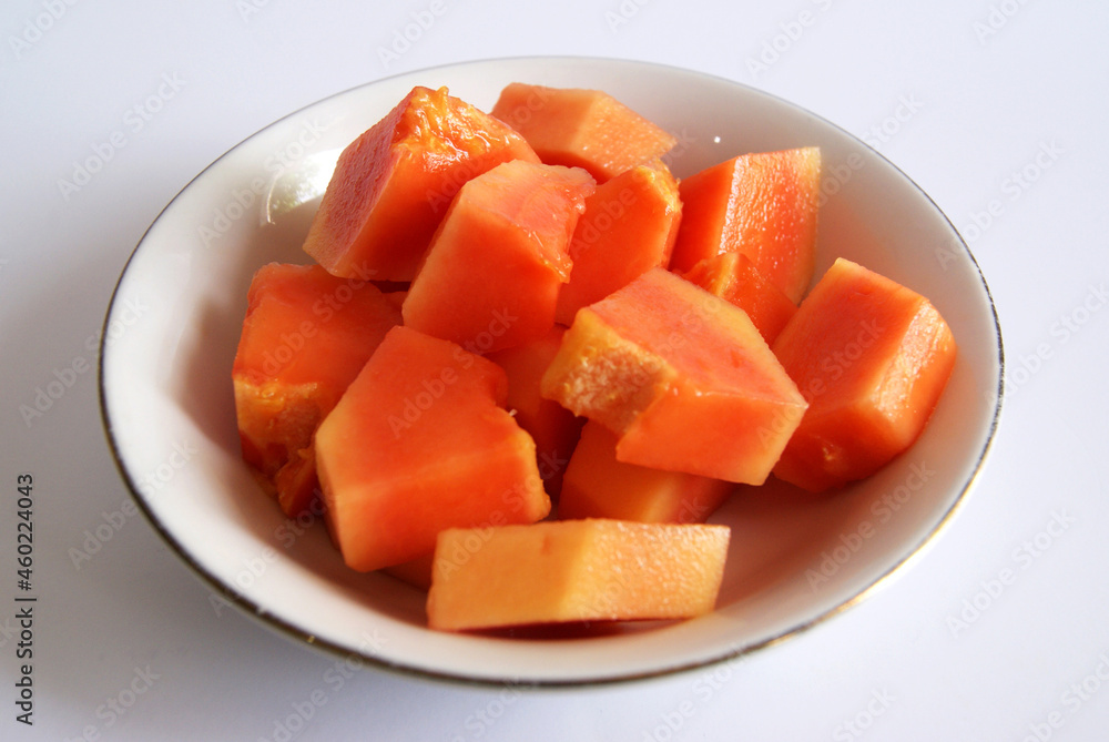 A bowl fresh papaya isolated on whote background. Close up photo of papaya. A bowl fresh papaya isolated on whote background. Close up photo of papaya.