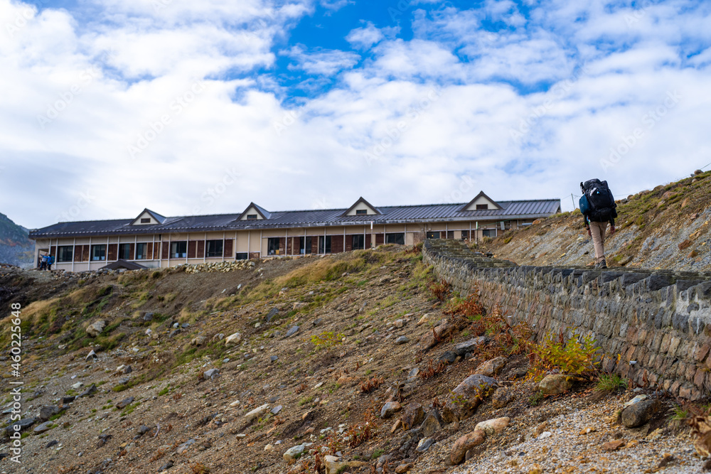 富山県立山町の立山の秋の紅葉の季節に登山している風景 Scenery of climbing Tateyama Mountain in Tateyama Town, Toyama Prefecture, Japan during the season of autumn leaves. 富山県立山町の立山の秋の紅葉の季節に登山している風景 Scenery of climbing Tateyama Mountain in Tateyama Town, Toyama Prefecture, Japan during the season of autumn leaves.