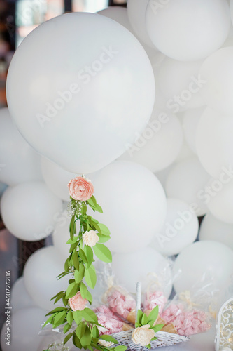 White balloons with paper flower garland photo