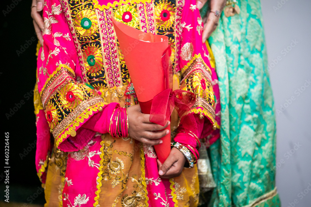 Indian bridesmaids' hands holding petals close up