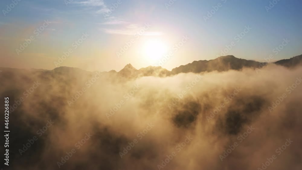 Drone flying through beautiful golden sunny cloudscape at sunrise 4K. Amazing aerial shot of heaven clouds in blue sky. Cinematic 4K of sun shining above clouds and mountains with beautiful lens flare Drone flying through beautiful golden sunny cloudscape at sunrise 4K. Amazing aerial shot of heaven clouds in blue sky. Cinematic 4K of sun shining above clouds and mountains with beautiful lens flare