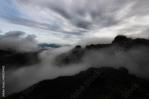 Mountain landscape in the evening with the play of clouds between the peaks