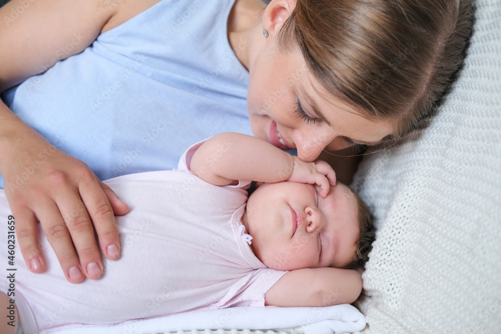 Attractive happy mothers face kiss sleepy little baby girl. Happy family Attractive happy mothers face kiss sleepy little baby girl. Happy family