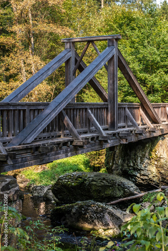 Old wooden bridge "Teufelssteg" over a river with rocks in Höllental Upper Franconia