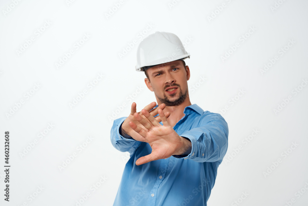 worker in a white helmet construction industry light background