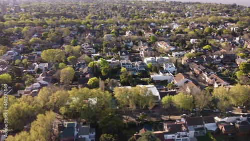 Aerial view showing Rural San Isidro Suburb of Buenos Aires during summer - Residential Area with green trees and River Plate in background photo