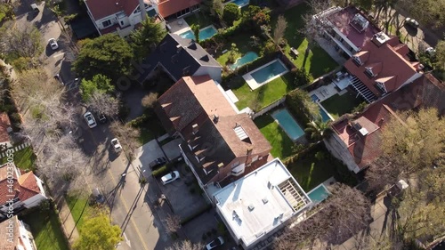 Aerial flyover luxury neighborhood with swimming pool in garden and villas in Vicente Lopez Suburb of Buenos Aires