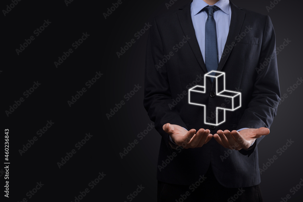 Businessman hold 3D plus icon, man hold in hand offer positive thing such as profit, benefits, development, CSR represented by plus sign.The hand shows the plus sign Businessman hold 3D plus icon, man hold in hand offer positive thing such as profit, benefits, development, CSR represented by plus sign.The hand shows the plus sign