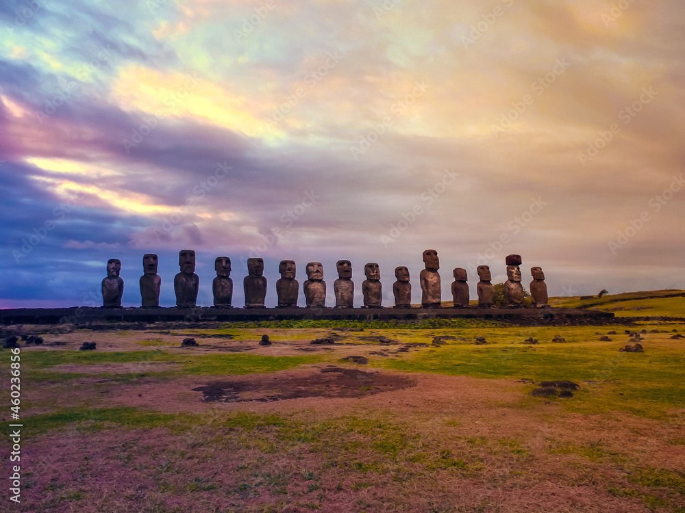 Moai statues with colorful clouds on Easter Island on sunset. Ahu Tongariki against Blue Sky, Chile, South America