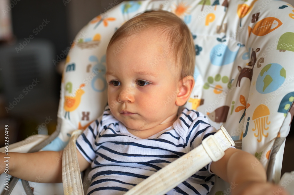 Adorable little baby sitting in high chair Adorable little baby sitting in high chair