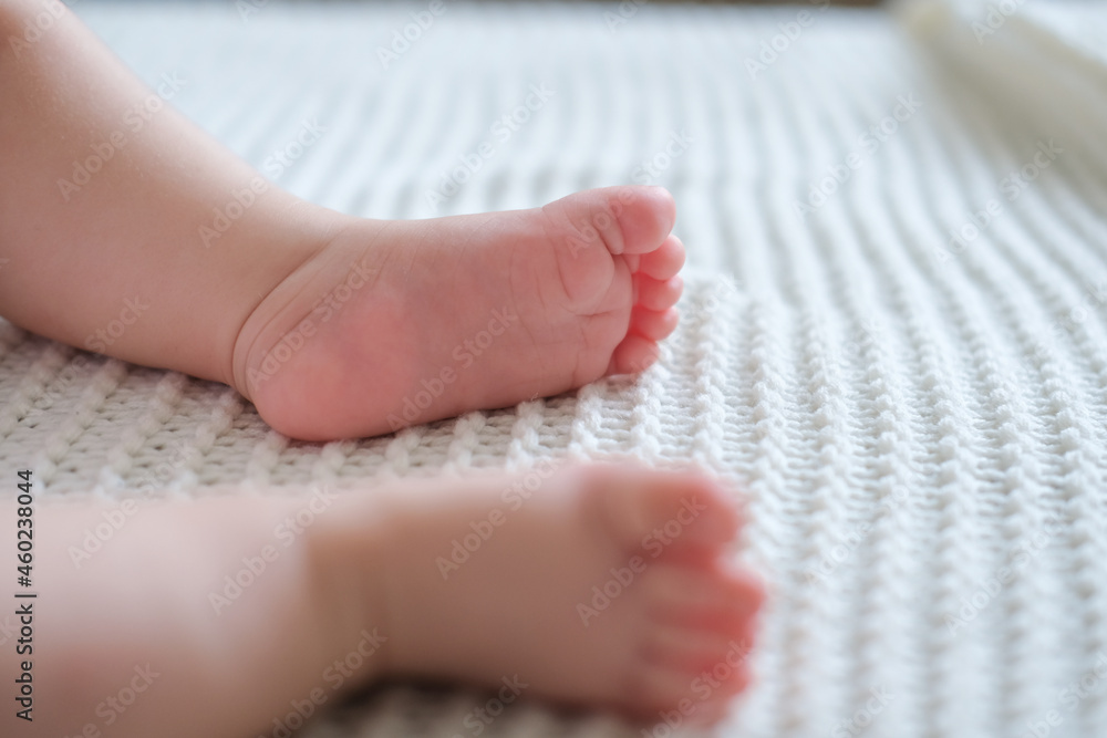 little babys bare foot on white plaid. Happy family little babys bare foot on white plaid. Happy family