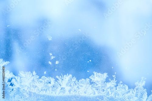 Winter ice frost, frozen background. The texture of frosted window glass. Cool cool background of snowflakes. Winter Wonderland Scene. High quality photo