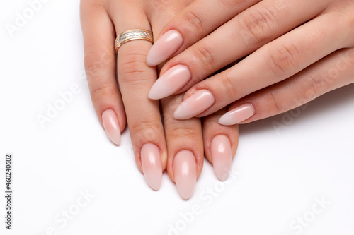 Wedding manicure white ombre on long sharp nails close-up on a white background