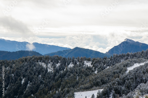 Winters mountain range landscape and view, snow and cloudy sky