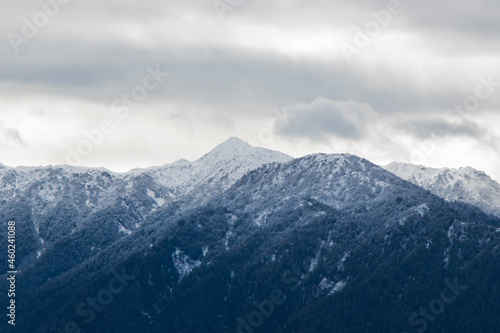 Winters mountain range landscape and view, snow and cloudy sky © taidundua