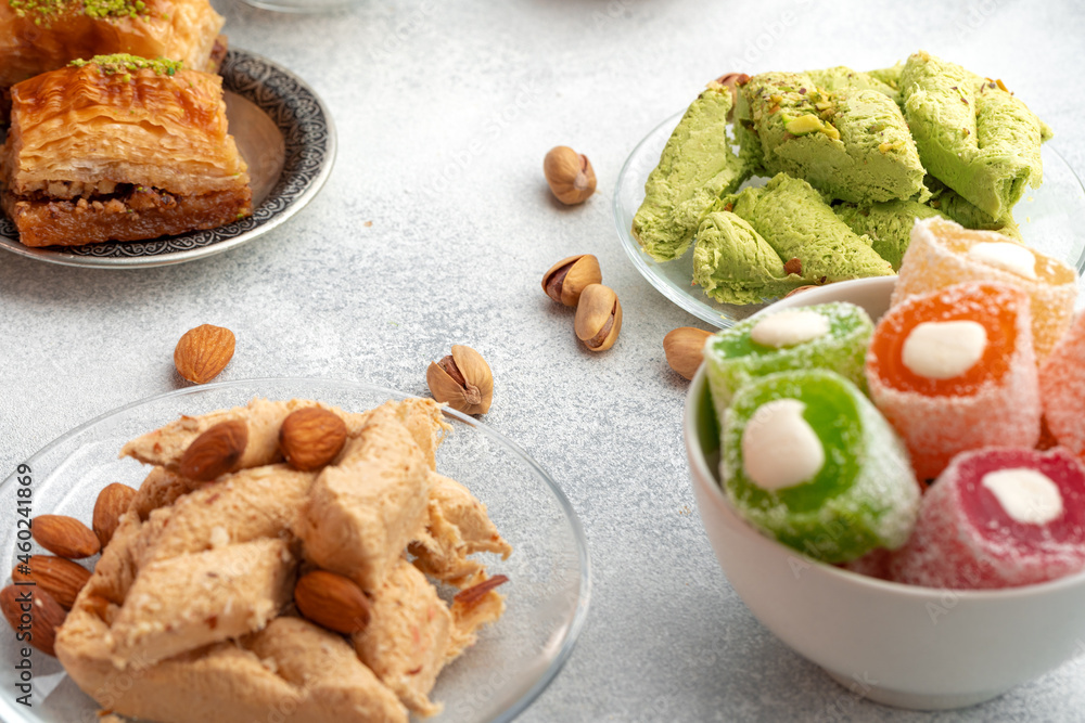 Close up of colorful Turkish halva sweets on gray surface