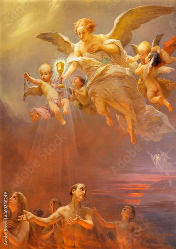 ROME, ITALY - AUGUST 28, 2021: The painting Angels liberated the souls from the purgatory with Eucharist, rosary and scapular in the church Chiesa San Giacomo in Augusta by E. Ballerini (1917).