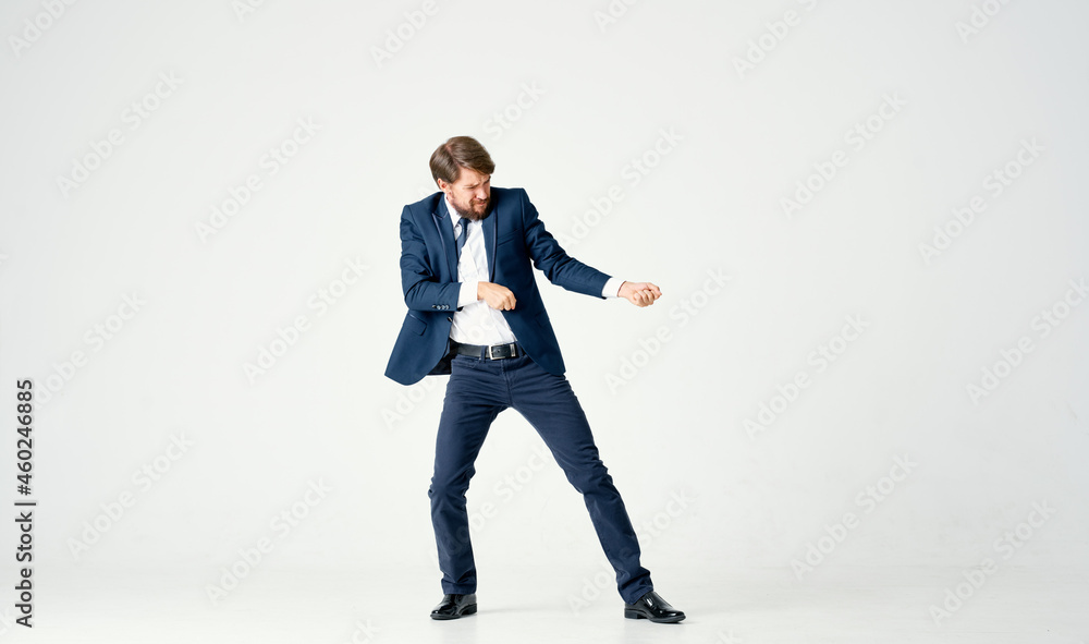 The man in a suit posing executive light background The man in a suit posing executive light background