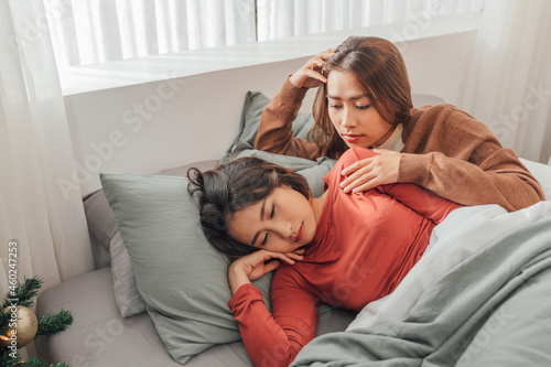Two pretty best friends forever girlfriend talk, hug and laugh together on bed at cozy home relation fall in love