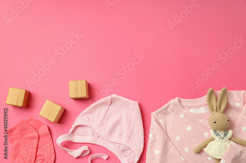 Fototapeta Naklejka Na Ścianę i Meble -  Concept of female baby clothes on pink background
