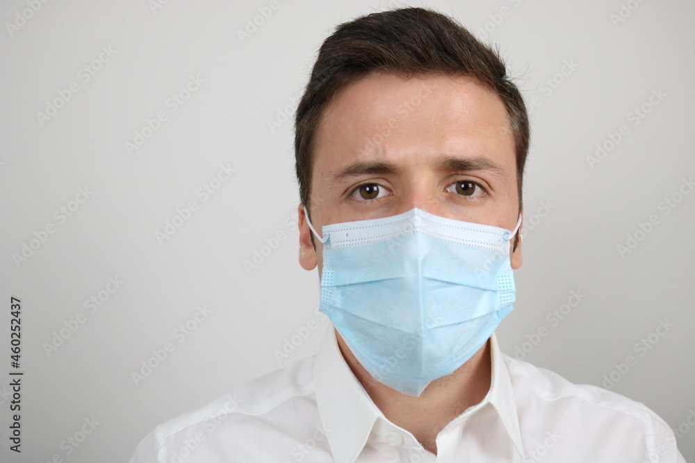 Elegant caucasian man wearing surgical face mask. Preventing Covid-19 spread Elegant caucasian man wearing surgical face mask. Preventing Covid-19 spread
