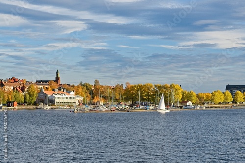 A white sailboat enters the marina in the center of Östersund