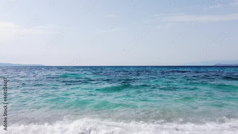 Aerial drone view of waves crushing on tropical beach with sand. Waves breaking on the shore at sunset. Transparent sea water. Fly with a drone above sea waves. Aerial drone view of waves crushing on tropical beach with sand. Waves breaking on the shore at sunset. Transparent sea water. Fly with a drone above sea waves.