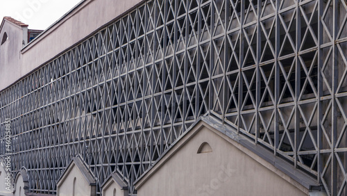 Car parking building with metal grille. Abstract steel surface with copy space. Urban concept.