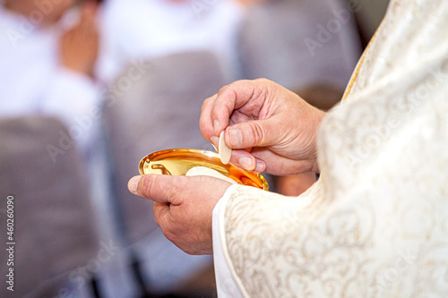 Priest and communion in hand