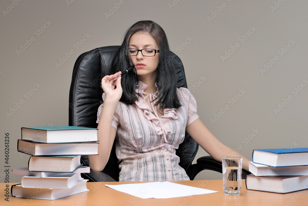 Young pretty businesswoman sitting in office