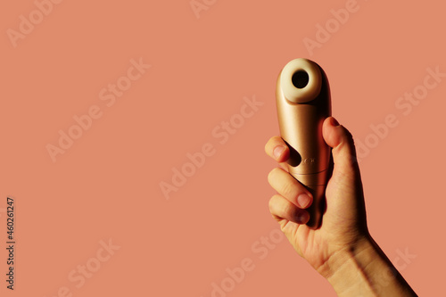 Woman holding clitoral vibrator. Sexual health. Copy space. Masturbation toy concept