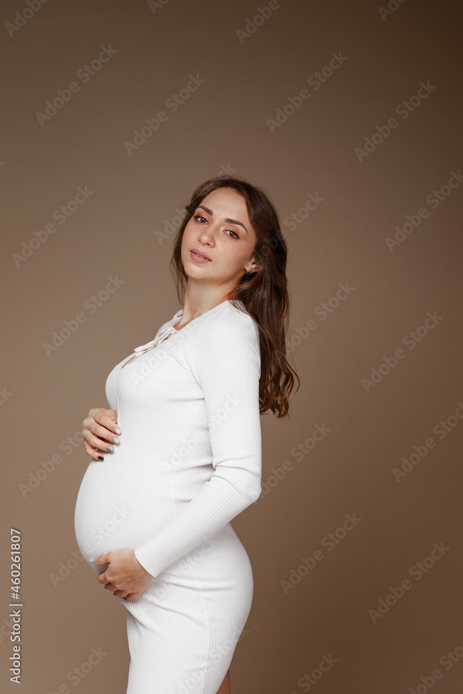 pregnant girl in studio on paper background pregnant girl in studio on paper background